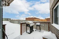 View of wooden balcony featuring grilling area and a deck - 