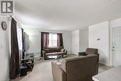 Living room featuring a textured ceiling and light colored carpet - 