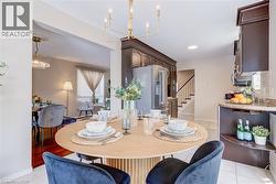 Dining room with a chandelier, light tile patterned floors, and stairway - 