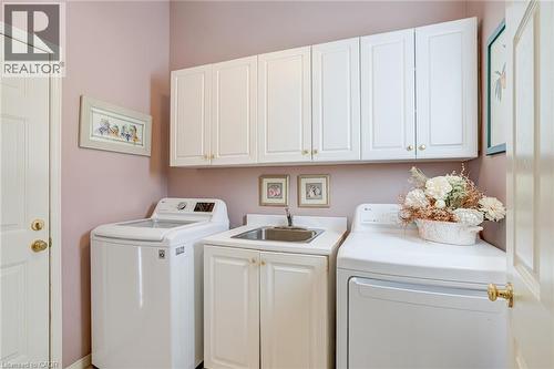 Laundry room featuring washer and dryer and cabinet space - 15 Claudette Gate, Hamilton, ON - Indoor Photo Showing Laundry Room