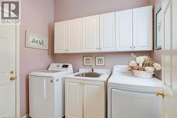 Laundry room featuring washer and dryer and cabinet space - 