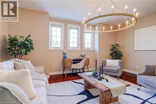Living room with wood finished floors and a chandelier - 15 Claudette Gate, Hamilton, ON - Indoor Photo Showing Living Room