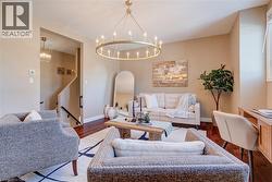 Living room with a chandelier and wood finished floors - 