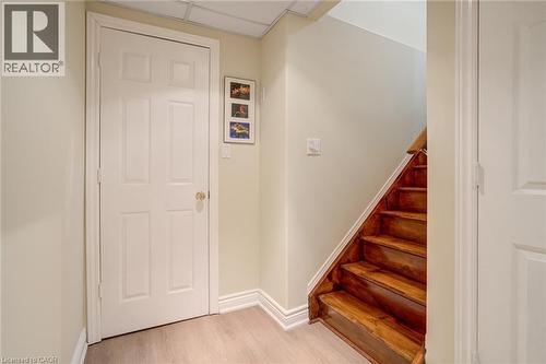 Stairway with wood finished floors and baseboards - 15 Claudette Gate, Hamilton, ON - Indoor Photo Showing Other Room