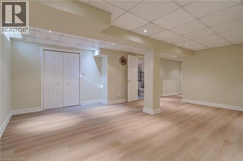 Finished basement with a drop ceiling and light wood-type flooring - 15 Claudette Gate, Hamilton, ON - Indoor