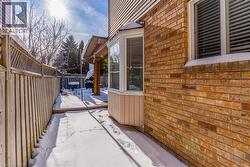 Snow covered patio featuring a fenced backyard - 