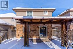 Snow covered property entrance with brick siding - 