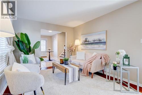 Living room featuring wood finished floors and stairway - 15 Claudette Gate, Hamilton, ON - Indoor Photo Showing Living Room