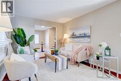 Living room featuring wood finished floors and stairway - 