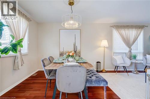 Dining area with dark wood finished floors, plenty of natural light, and a chandelier - 15 Claudette Gate, Hamilton, ON - Indoor Photo Showing Dining Room
