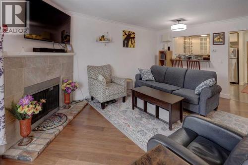 101, 1821 17A Street Sw, Calgary, AB - Indoor Photo Showing Living Room With Fireplace