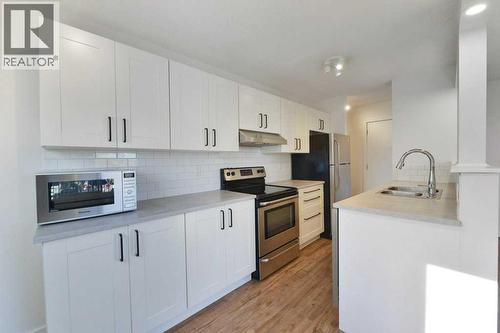 204, 2220 16A Street Sw, Calgary, AB - Indoor Photo Showing Kitchen With Stainless Steel Kitchen With Double Sink