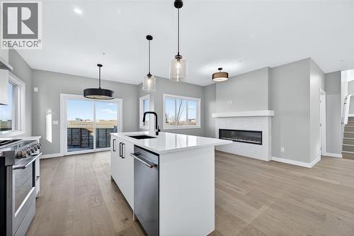 150 Prince Crescent, Rural Rocky View County, AB - Indoor Photo Showing Kitchen With Fireplace With Stainless Steel Kitchen With Upgraded Kitchen