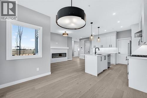 150 Prince Crescent, Rural Rocky View County, AB - Indoor Photo Showing Kitchen With Fireplace