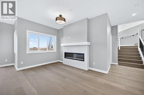 150 Prince Crescent, Rural Rocky View County, AB - Indoor Photo Showing Living Room With Fireplace