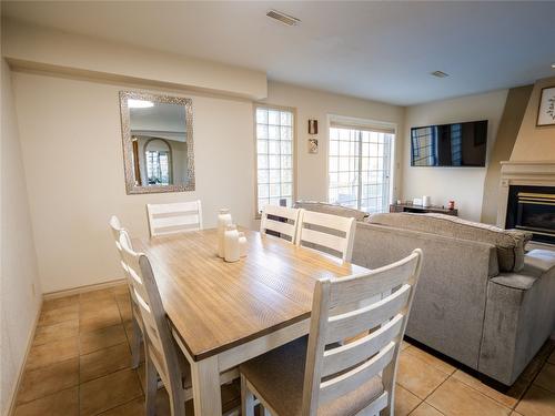 3-6811 Cottonwood Drive, Osoyoos, BC - Indoor Photo Showing Dining Room With Fireplace