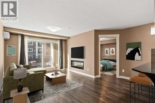 2209, 450 Sage Valley Drive Nw, Calgary, AB - Indoor Photo Showing Other Room With Fireplace