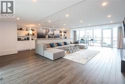 Living area featuring hardwood / wood-style flooring, expansive windows, and recessed lighting - 