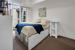 Bedroom featuring dark carpet and baseboards - 