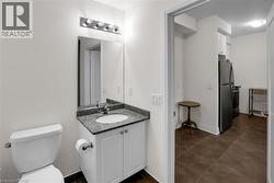 Half bathroom with vanity and dark tile patterned flooring - 