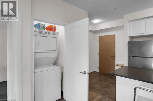 Laundry area with stacked washer and clothes dryer - 16 Concord Place Unit# 431, Grimsby, ON - Indoor Photo Showing Laundry Room