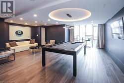 Recreation room with pool table, expansive windows, and recessed lighting - 