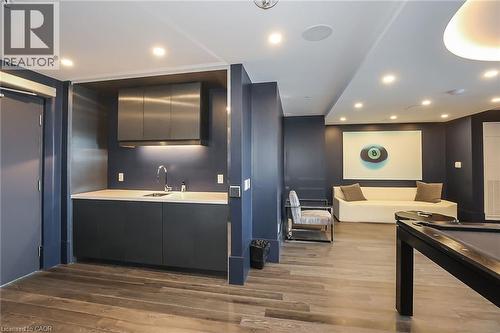 Bar area with recessed lighting, modern cabinets, light countertops, and dark wood-type flooring - 16 Concord Place Unit# 431, Grimsby, ON - Indoor