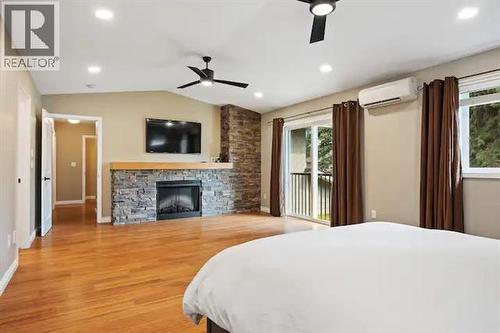 759 Mcclure Road, Kelowna, BC - Indoor Photo Showing Bedroom With Fireplace