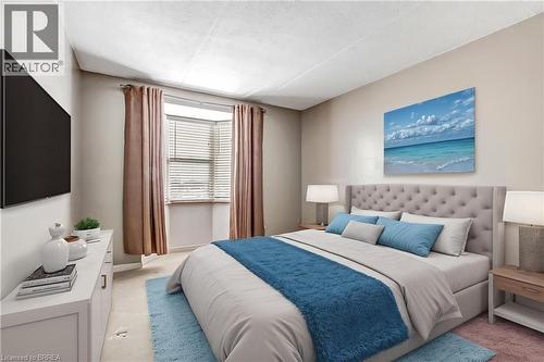 Large primary bedroom with bow window.  Virtually staged. - 88 Tollgate Road Unit# 402, Brantford, ON - Indoor Photo Showing Bedroom