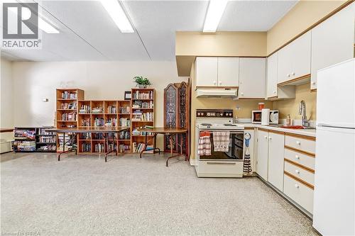 Building's community room.  Library, kitchen, bath.  Available for entertaining. - 88 Tollgate Road Unit# 402, Brantford, ON - Indoor Photo Showing Other Room