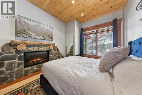 1783 Greywolf Drive, Panorama, BC - Indoor Photo Showing Bedroom With Fireplace