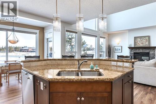82 Auburn Sound Landing Se, Calgary, AB - Indoor Photo Showing Kitchen With Fireplace With Double Sink
