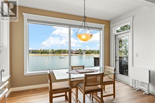 82 Auburn Sound Landing Se, Calgary, AB - Indoor Photo Showing Dining Room With Body Of Water