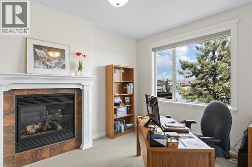 82 Auburn Sound Landing Se, Calgary, AB - Indoor Photo Showing Office With Fireplace