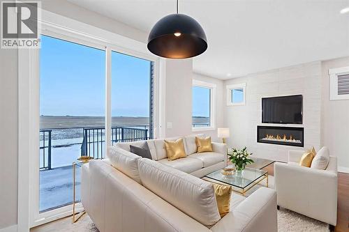 56 Bridges Drive, Langdon, AB - Indoor Photo Showing Living Room With Fireplace