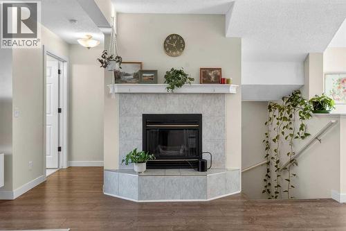 41 Sandarac Villas Nw, Calgary, AB - Indoor Photo Showing Living Room With Fireplace