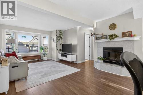 41 Sandarac Villas Nw, Calgary, AB - Indoor Photo Showing Living Room With Fireplace