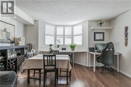 Dining area featuring dark wood-style floors, a textured ceiling, and an office area - 3845 Lakeshore Boulevard W Unit# 804, Etobicoke, ON - Indoor Photo Showing Dining Room