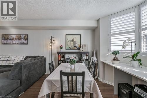 Dining area featuring dark wood-style flooring and a textured ceiling - 3845 Lakeshore Boulevard W Unit# 804, Etobicoke, ON - Indoor Photo Showing Dining Room