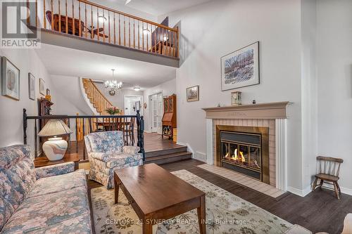 Living Area w/ Wood Fireplace - 16 - 32 Innesbrook Court, Ottawa, ON - Indoor Photo Showing Living Room With Fireplace