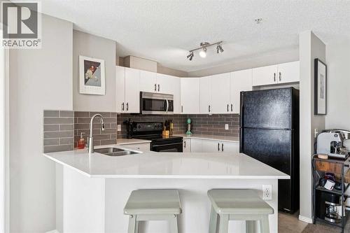 1215, 8810 Royal Birch Boulevard, Calgary, AB - Indoor Photo Showing Kitchen With Double Sink