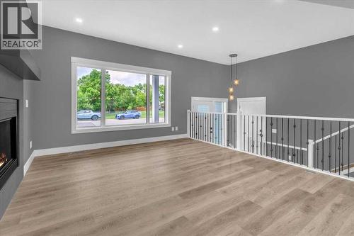 2016 30 Avenue, Nanton, AB - Indoor With Fireplace