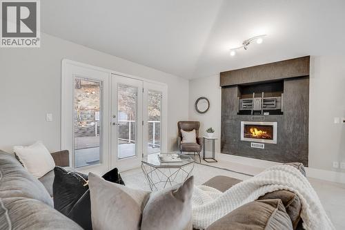 Comfortable family room with direct access to outdoor space. - 2034 Horizon Drive, West Kelowna, BC - Indoor Photo Showing Living Room With Fireplace
