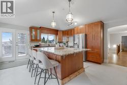 Spacious kitchen with a large island, ample counter space, and room for everyday cooking and entertaining. - 