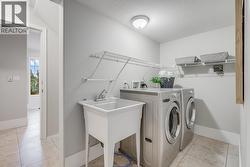 Shared laundry room with additional storage options. - 