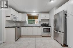 Lower-level suite kitchen with functional layout and private entrance. - 