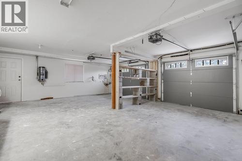 Attached double garage offering secure parking and extra storage. - 2034 Horizon Drive, West Kelowna, BC - Indoor Photo Showing Garage