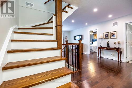 Elegant Wood Staircase With Wrought Iron Railings - 61 Druan Drive, Kawartha Lakes (Mariposa), ON - Indoor Photo Showing Other Room