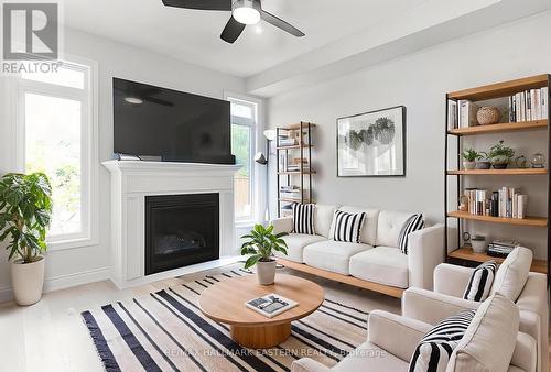Living area with gas fireplace overlooks backyard - 34 Coldbrook Drive, Cavan Monaghan (Millbrook Village), ON - Indoor Photo Showing Living Room With Fireplace