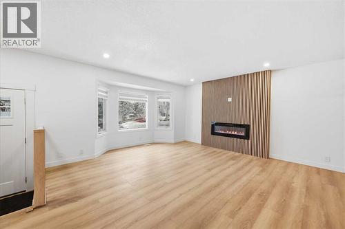 Family room - main - 2404 51 Street Ne, Calgary, AB - Indoor Photo Showing Living Room With Fireplace